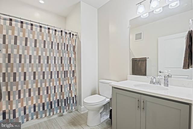 bathroom featuring vanity, a shower with shower curtain, and toilet