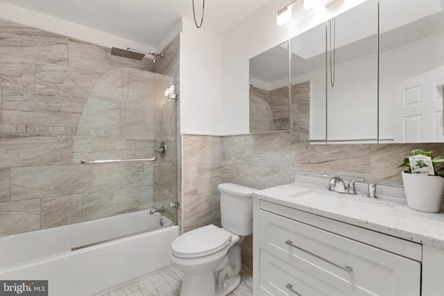 full bathroom featuring marble finish floor, tasteful backsplash, toilet, enclosed tub / shower combo, and vanity