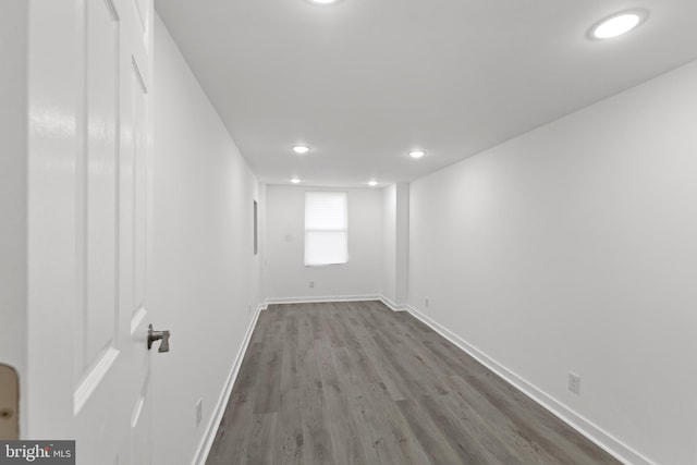 empty room featuring recessed lighting, wood finished floors, and baseboards