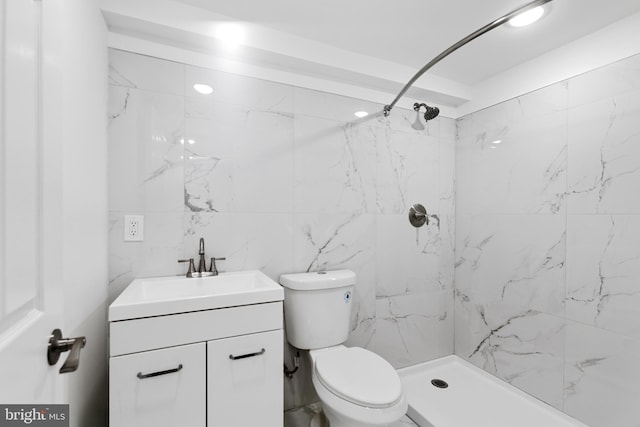 full bathroom featuring toilet, a shower stall, and vanity