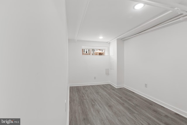 basement featuring recessed lighting, wood finished floors, and baseboards