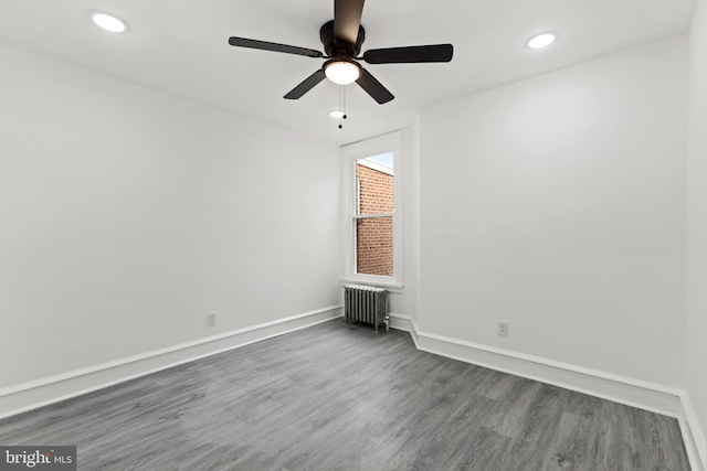 unfurnished room with ceiling fan, recessed lighting, baseboards, radiator heating unit, and dark wood finished floors