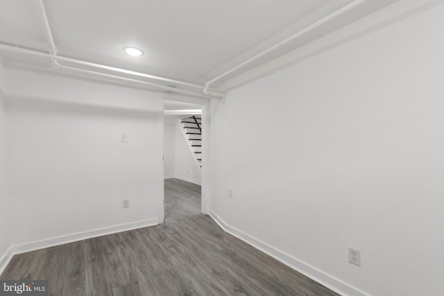 basement with dark wood-type flooring, recessed lighting, baseboards, and stairs