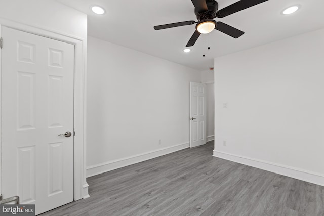 unfurnished room featuring ceiling fan, baseboards, wood finished floors, and recessed lighting