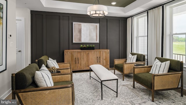 living area featuring a tray ceiling