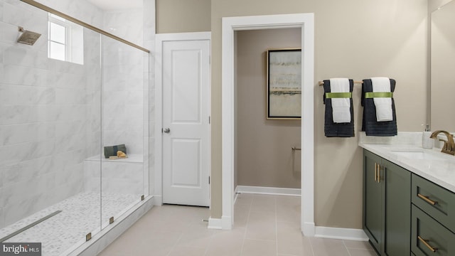 bathroom featuring tile patterned flooring, vanity, and a shower with shower door