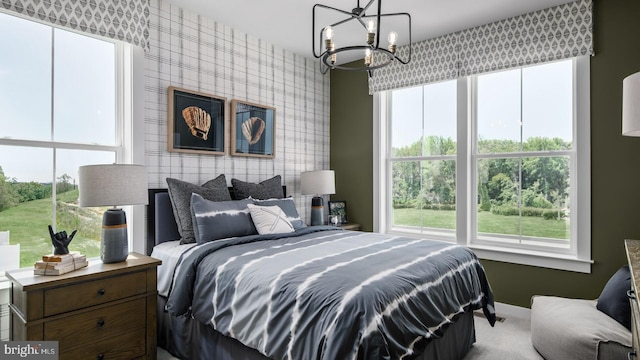 carpeted bedroom with a chandelier and multiple windows