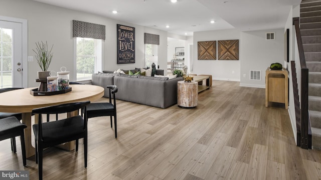 dining space with light hardwood / wood-style flooring