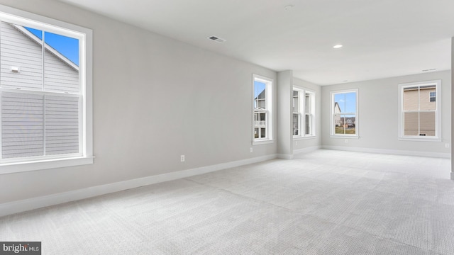 spare room featuring light colored carpet