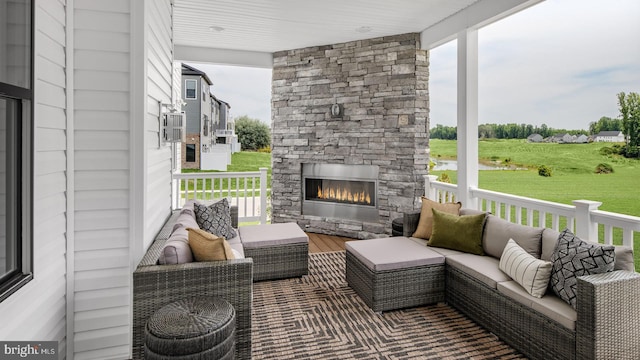 exterior space with an outdoor living space with a fireplace