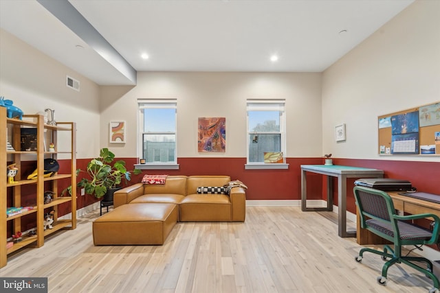 home office with light hardwood / wood-style floors