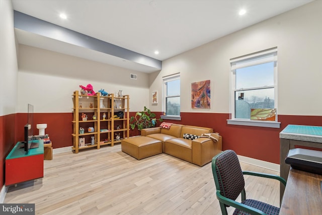 living room featuring a wealth of natural light and light hardwood / wood-style floors