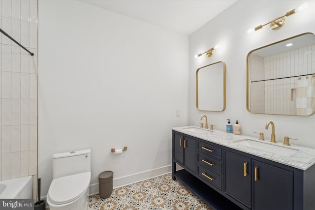 full bathroom with vanity, tiled shower / bath, and toilet