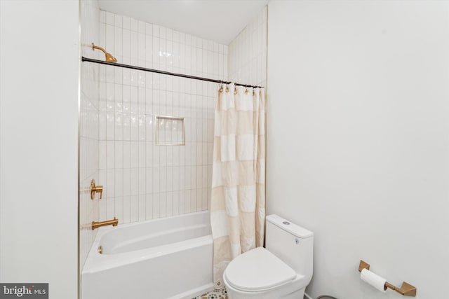 bathroom featuring shower / bath combination with curtain and toilet