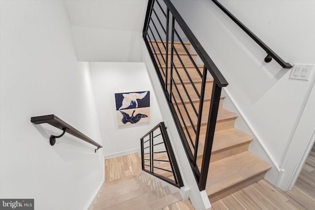 stairway featuring hardwood / wood-style floors