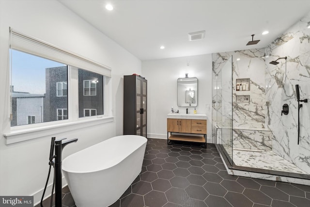 bathroom with vanity and independent shower and bath