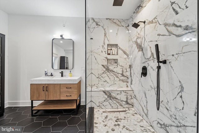 bathroom featuring vanity, tile patterned flooring, and a tile shower