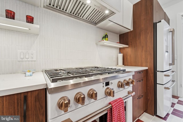 kitchen featuring premium range hood, high end appliances, and decorative backsplash