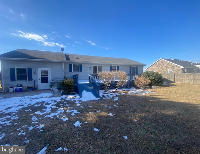 rear view of property featuring a wooden deck