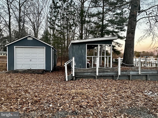 exterior space with a garage and an outdoor structure