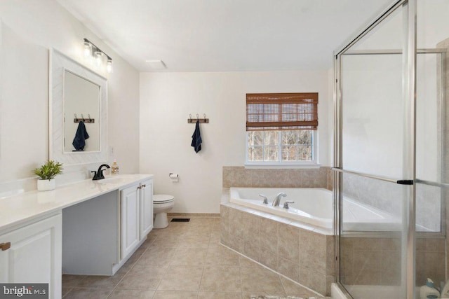 full bathroom with vanity, tile patterned floors, toilet, and separate shower and tub