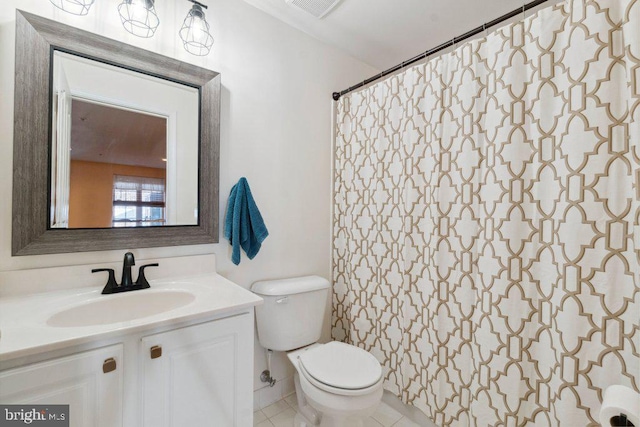 bathroom featuring vanity, tile patterned flooring, and toilet