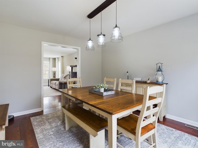 dining space with dark hardwood / wood-style floors