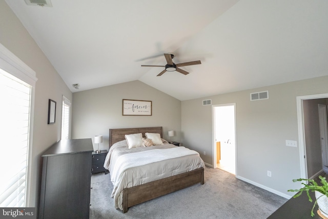 carpeted bedroom featuring ensuite bathroom, lofted ceiling, and ceiling fan