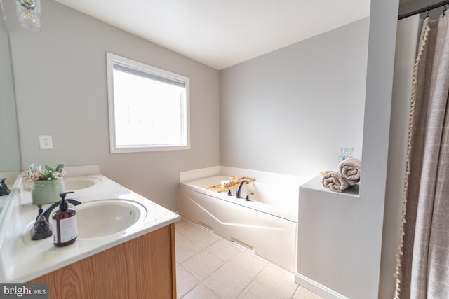 bathroom featuring tile patterned floors, a bathing tub, and vanity