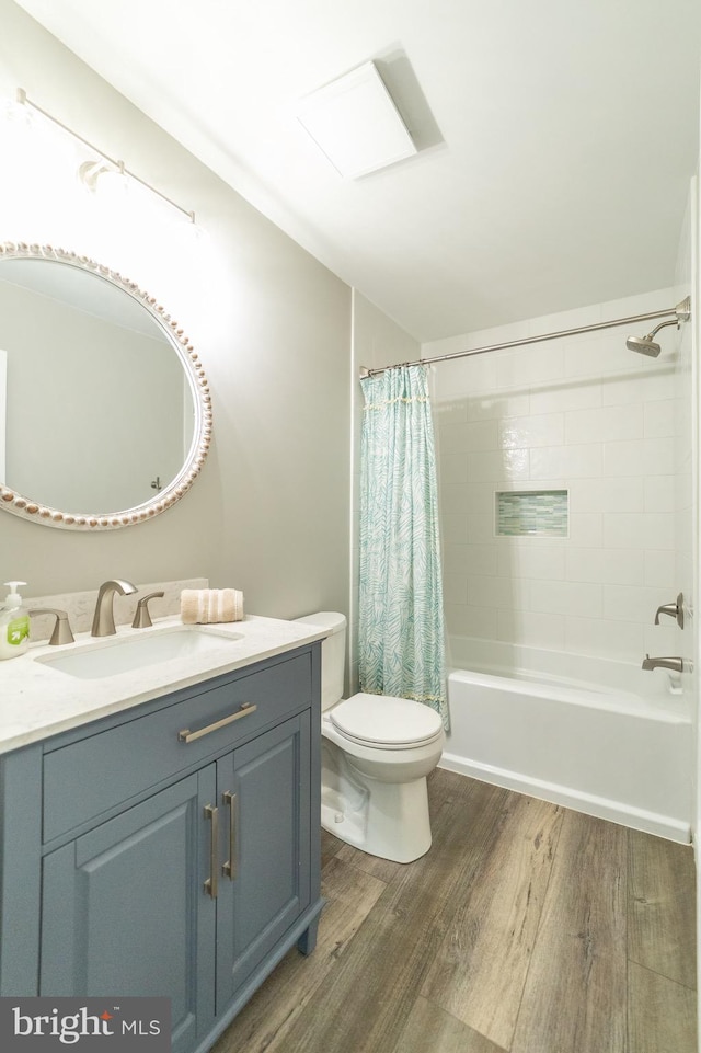 full bathroom featuring vanity, hardwood / wood-style flooring, toilet, and shower / bath combo with shower curtain