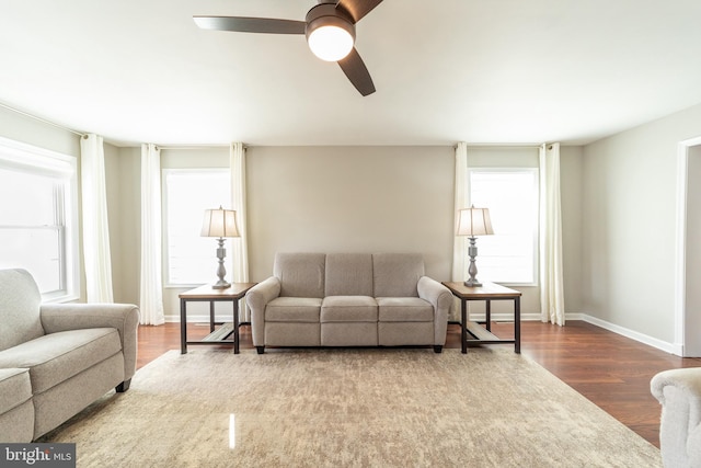 living room with wood-type flooring, plenty of natural light, and ceiling fan