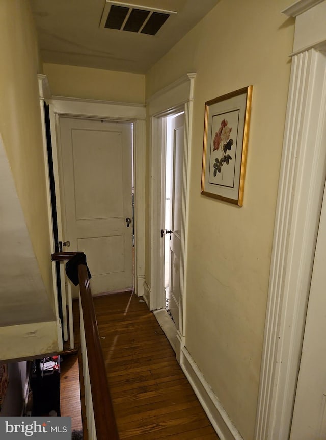 hallway with dark wood-type flooring