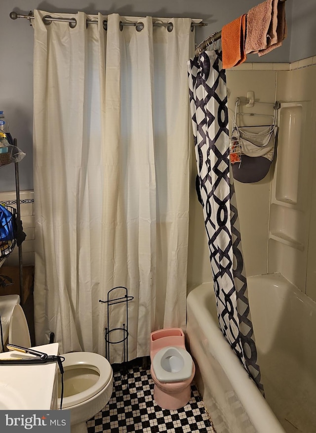 bathroom with toilet and shower / bath combo