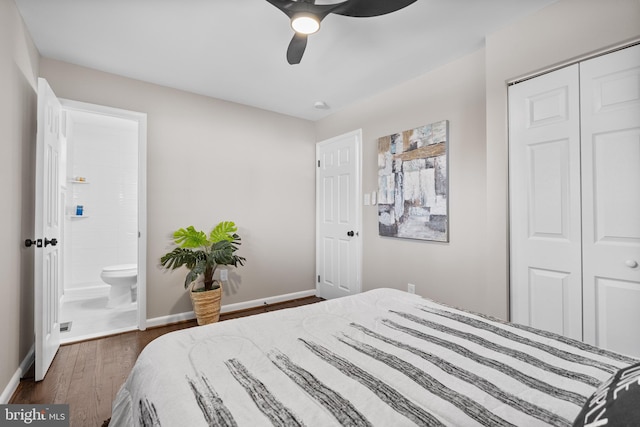 bedroom with dark wood-type flooring, a closet, and ceiling fan