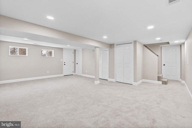 basement featuring light carpet