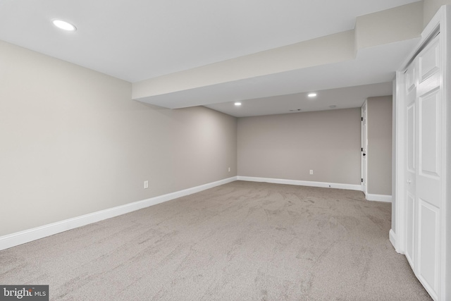 basement featuring light carpet