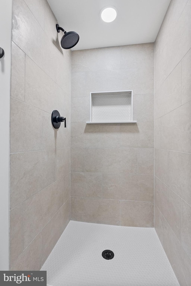 bathroom with tiled shower