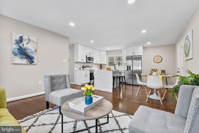 living room with dark hardwood / wood-style flooring