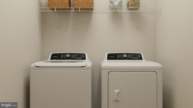 clothes washing area with separate washer and dryer