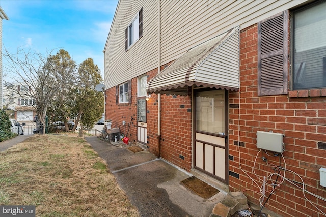 view of side of home featuring a lawn