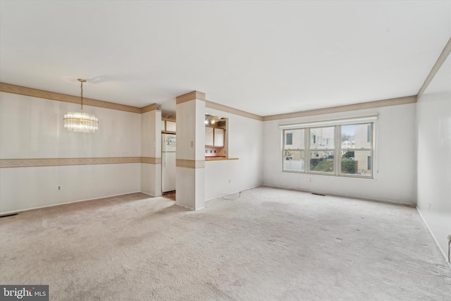 unfurnished living room with light colored carpet and an inviting chandelier