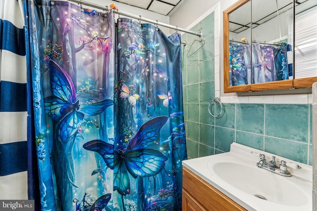 bathroom featuring tile walls and vanity