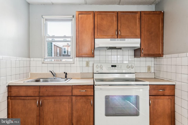 kitchen with tile walls, sink, and white electric range oven