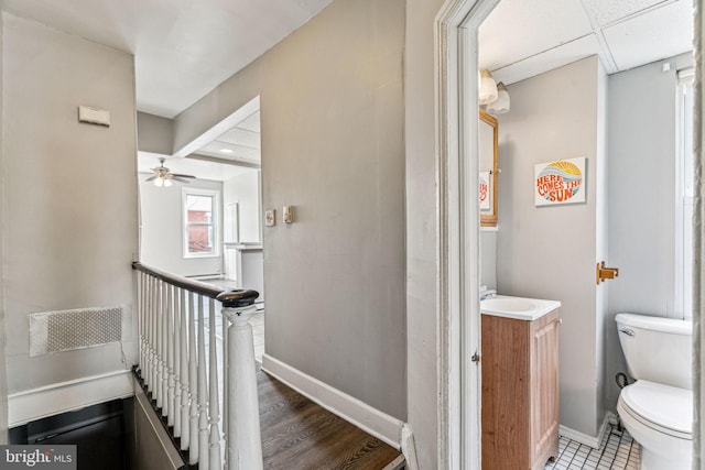 interior space with a paneled ceiling and sink