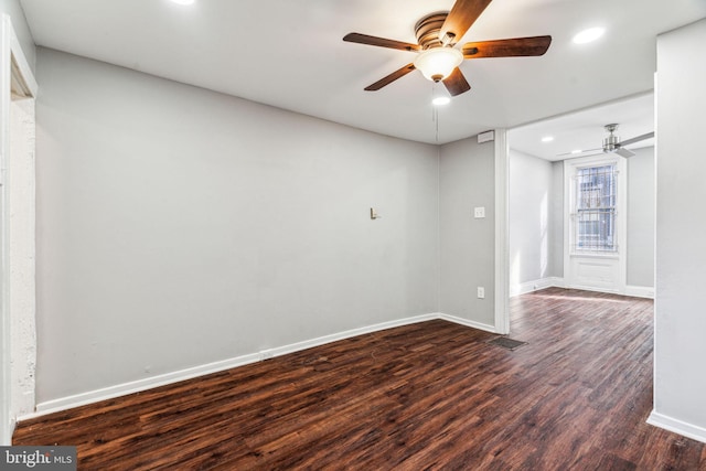 unfurnished room with dark hardwood / wood-style flooring and ceiling fan