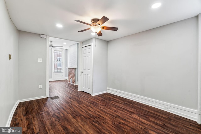 unfurnished room featuring dark hardwood / wood-style floors and ceiling fan