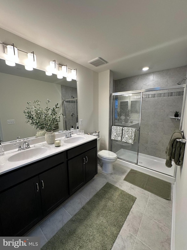 bathroom with vanity, a shower with shower door, and toilet