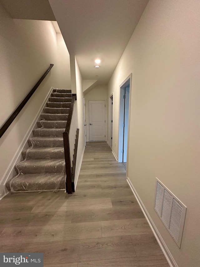 stairs with hardwood / wood-style flooring