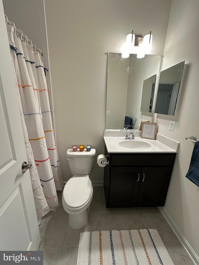 bathroom with tile patterned floors, vanity, and toilet