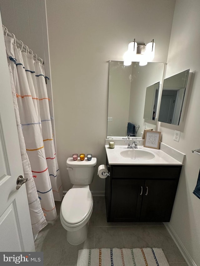 bathroom with walk in shower, tile patterned floors, vanity, and toilet